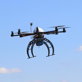 Drone in the air over a field.