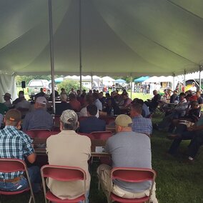 Attendees under a tent at a previous Water and Crops Field Day