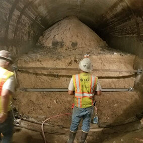 Workers examine the site of the smaller of the two tunnel collapses.