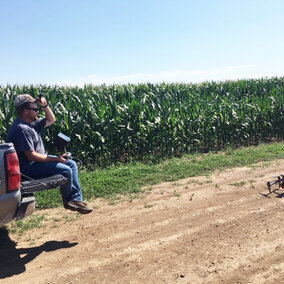 Nate Thompson prepares to launch a drone used in an NCR SARE-funded on-farm research project to assess using drone sensors for in-season nitrogen management. (Photo by Gary Lesoing)