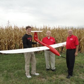 (From left) Matt Headrick, George Meyer and Wayne Woldt conduct a preflight check on an unmanned aircraft system. 