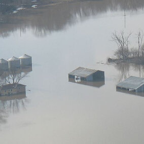 Aerial shot of grain bins in standing flood water