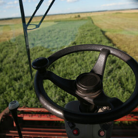 interior view of tractor in field while harvesting alfalfa