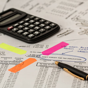 Calculator with financial papers