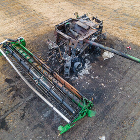 Aerial photo of burned combine in a scorched field