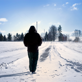 Man walking on snowy farm