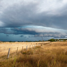 Hailstorm over farmland