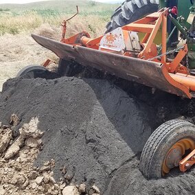 Figure 1. Coal combustion residue is being mixed into manure for land application.