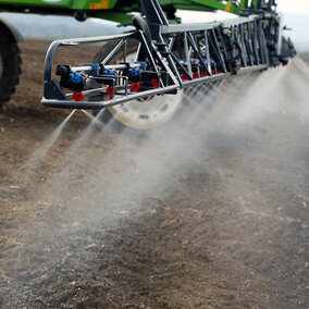 tractor spraying nitrogen on field