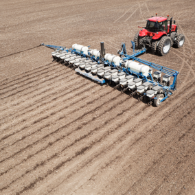 tractor planting field of corn
