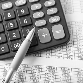 Calculator with financial papers