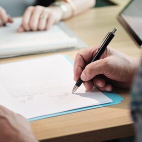 people signing legal documents