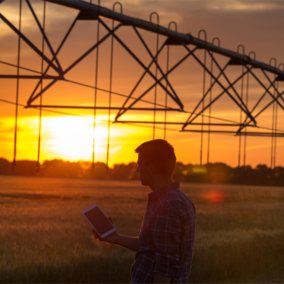 Farmer with tablet near pivot