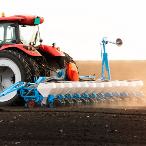 Tractor planting wheat in field