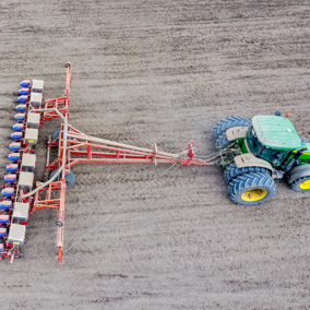 Tractor with seeder planting corn
