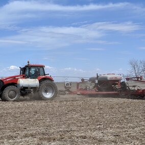 tractor planting corn in a field