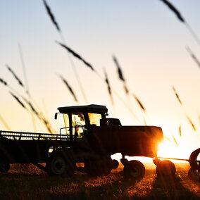 Tractor in field at sunset provides financial assistance for farmers, ranchers and forest landowners who experienced discrimination in USDA farm lending programs prior to January 2021. 