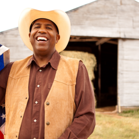 Man holding flag in front of barn