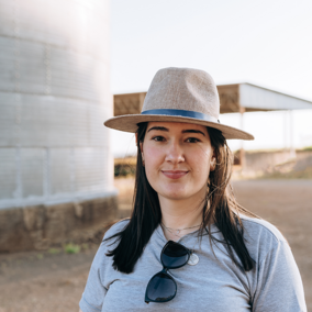 Woman farmer near grain bin