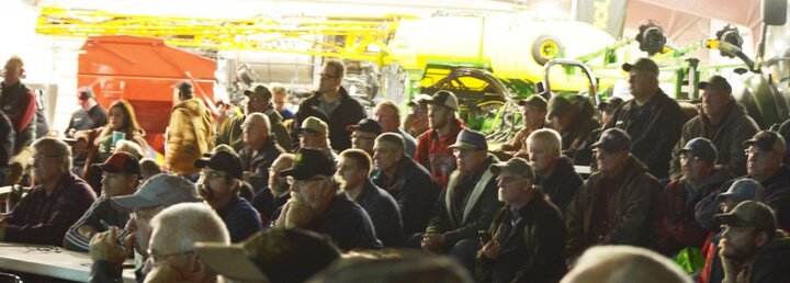 A group listening to a Soybean Expo Speaker