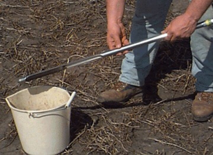 a soil sample probe, bucket, and sample bags