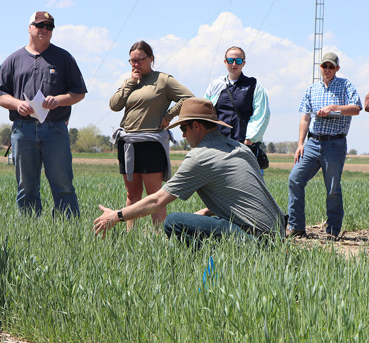 Aaron HIrd and attendees in field