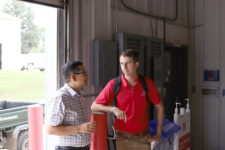 Bijesh Maharjan and Jim Jansen chat in doorway