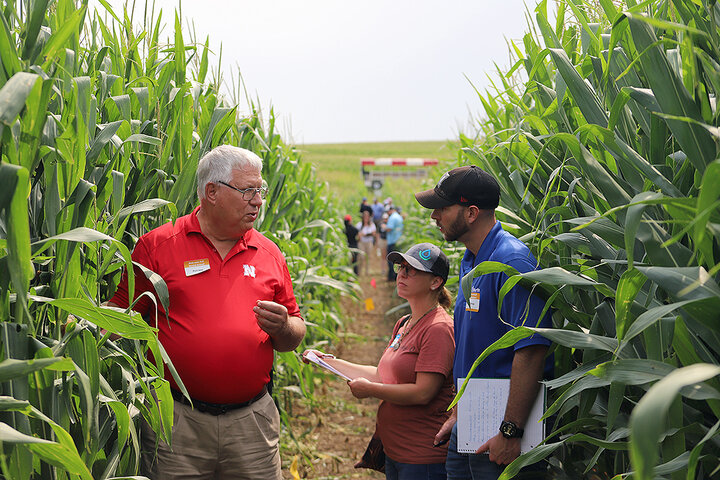 Paul Jasa talks to attendees in corn field