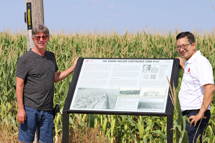 Ostdiek and Maharjan with sign