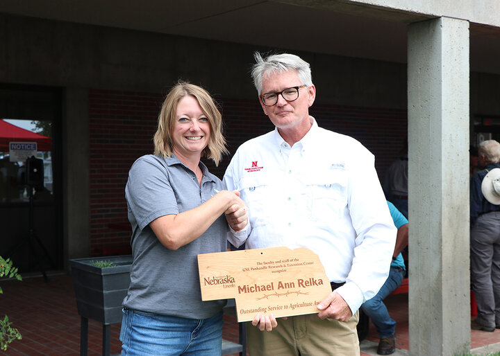 Michael Ann Relka and John Westra shake hands