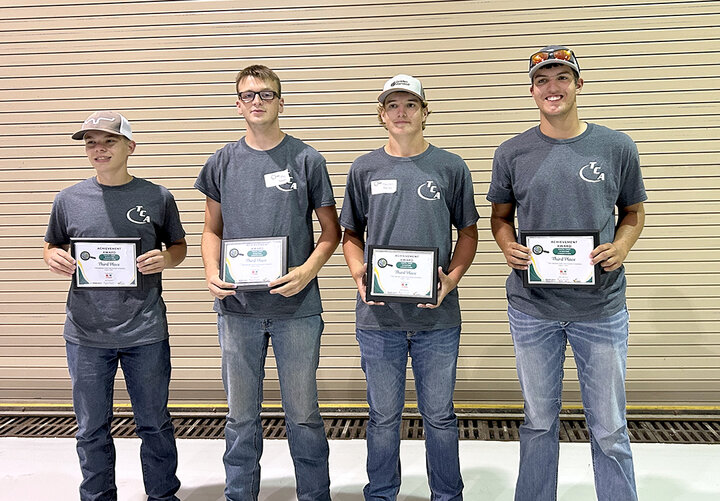 Team members hold plaques