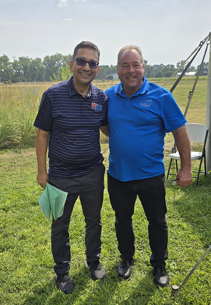 Two men pose for picture