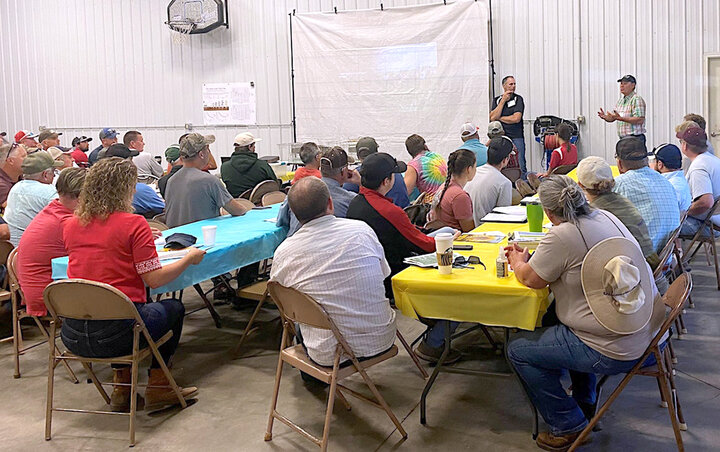 Attendees listen to presentation at conference