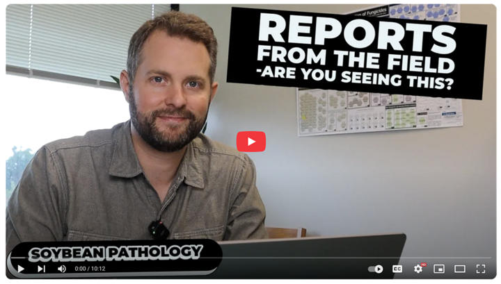 A man sits at a desk with a laptop, wearing a gray button-up shirt and microphone. A bold graphic reads “Reports from the Field — Are You Seeing This?” with a label below that says “Soybean Pathology.”