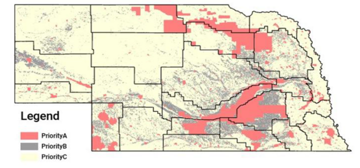 Nebraska map of NiRIA priority areas: Priority A (red) concentrated along the central Platte corridor and parts of the northeast and southwest; Priority B (gray) scattered in broad bands statewide; all other areas Priority C (pale yellow).