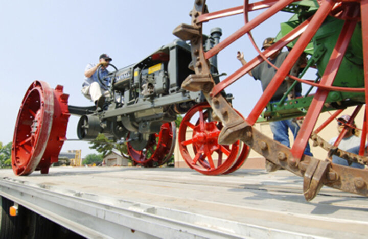 Photo of a McCormick-Deering Farmall tractor being loaded for the trip to the 100th American Society of Agricultural and Biological Engineers Annual Meeting.