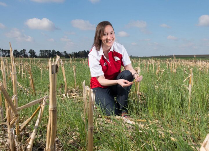 Andrea Basche in a corn-stubble cover crop field 