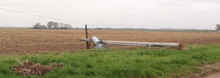 Power pole snapped over by high winds