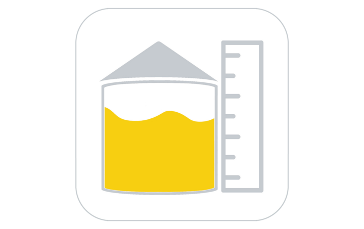 Yellow liquid in a container with a triangular lid, alongside a vertical ruler.