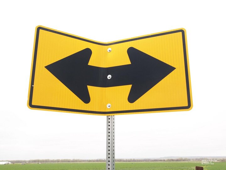 Wind-damaged metal sign