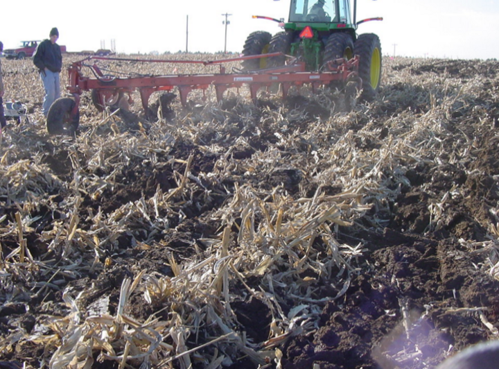 A tractor tilling a field