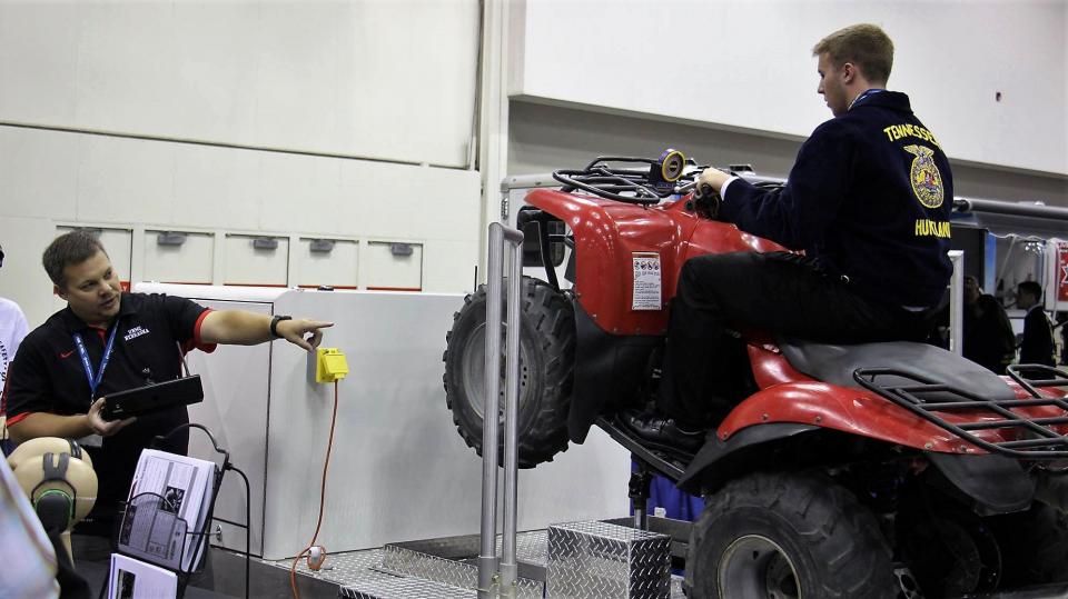 Figure 1. Aaron Yoder uses an ATV simulator at the National FFA Convention to provide safety training. Yoder will be one of the course instructors for the Youth Tractor Safety and Hazardous Occupations Course. 
