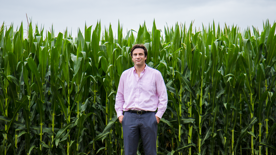 Patricio Grassini in front of corn field