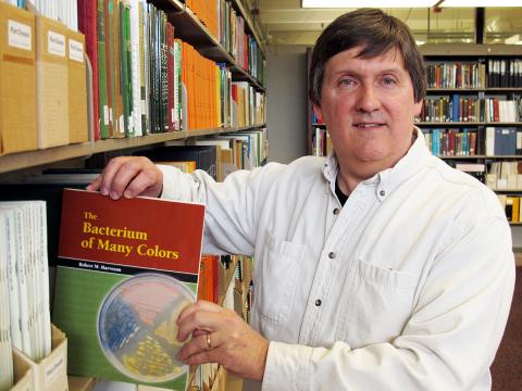 UNL Extension Plant Pathologist Bob Harveson with his book.