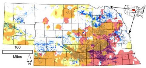 Distribution of the 1-square-kilometer cells where irrigated land in 2012 exceeded 50 percent of the cell area (blue-green dots) in Nebraska. Pink corresponds to declining annual, while yellow corresponds to declining irrigation-season (May-July) precipitation rates over the 1979-2015 period. The brownish color marks their spatial overlap.