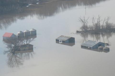 Aerial shot of grain bins in standing flood water