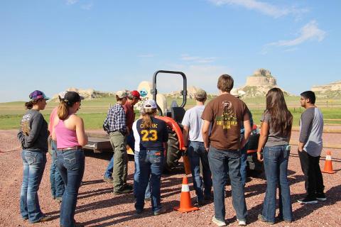 Teens participating in a tractor safety course