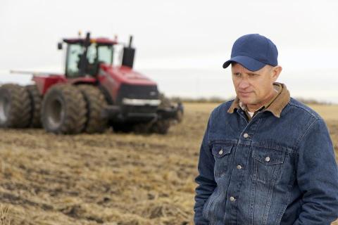 contemplative farmer in his field