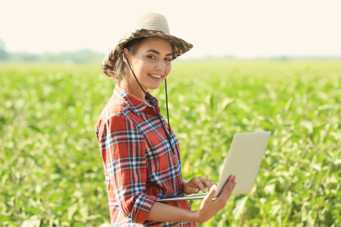 Farmer with laptop in field