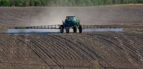 Tractor spraying soil